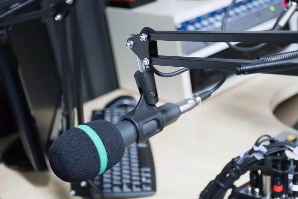 The studio desk with the boom-arm microphones