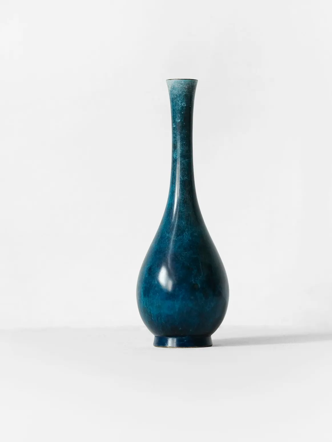 Blue stoneware vase against a plain background